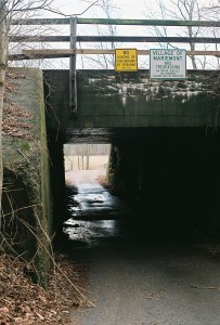 signs prohibit hunting and trespassing above the railroad underpass leading to Mariemont's lower 80 acres.
